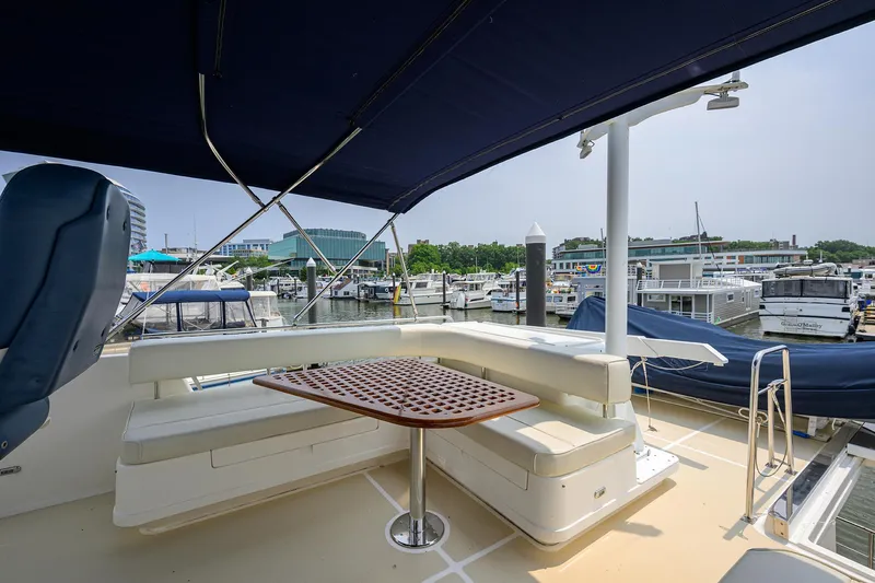 Teal Aweigh Yacht Photos Pics Luxurious 2011 Grand Banks 41 Europa yacht with shaded seating area at marina.