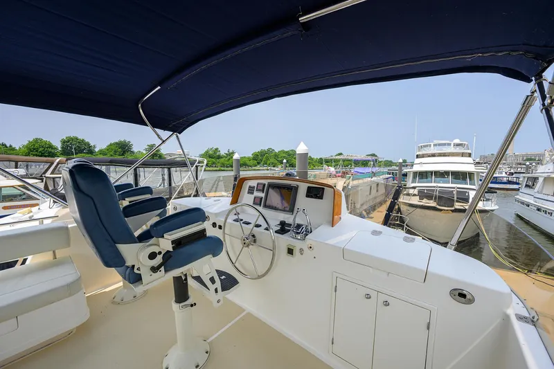 Teal Aweigh Yacht Photos Pics Flybridge of 2011 Grand Banks 41 Europa yacht with helm station and seating.