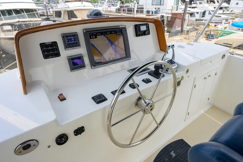 Teal Aweigh Yacht Photos Pics Helm of 2011 Grand Banks 41 Europa yacht with navigation equipment and steering wheel.