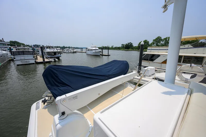 Teal Aweigh Yacht Photos Pics 2011 Grand Banks 41 Europa yacht docked at marina, covered equipment on deck.