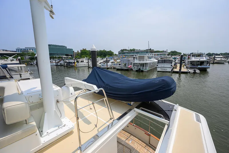 Teal Aweigh Yacht Photos Pics 2011 Grand Banks 41 Europa yacht docked at a marina with covered equipment.