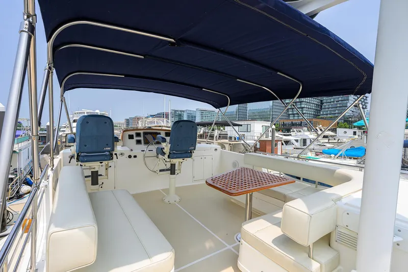 Teal Aweigh Yacht Photos Pics Flybridge of 2011 Grand Banks 41 Europa yacht with seating and helm under canopy.