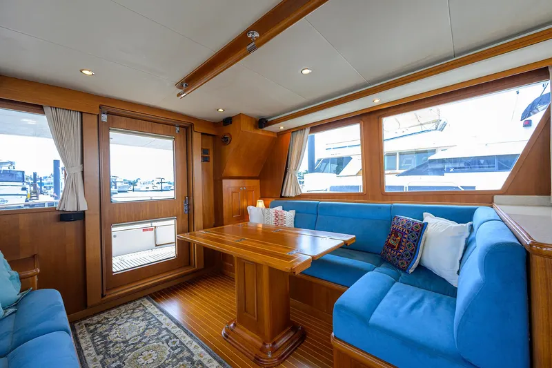 Teal Aweigh Yacht Photos Pics Interior of 2011 Grand Banks 41 Europa yacht with blue seating and wooden accents.