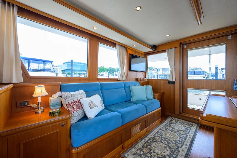 Teal Aweigh Yacht Photos Pics Luxurious interior of 2011 Grand Banks 41 Europa yacht with blue sofa and elegant decor.