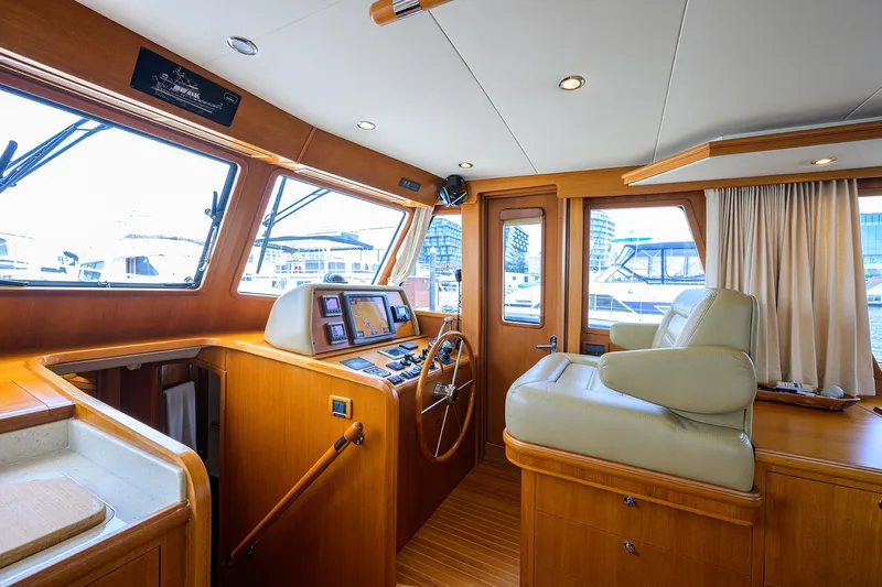 Teal Aweigh Yacht Photos Pics Interior of 2011 Grand Banks 41 Europa yacht with wooden helm and leather seating.