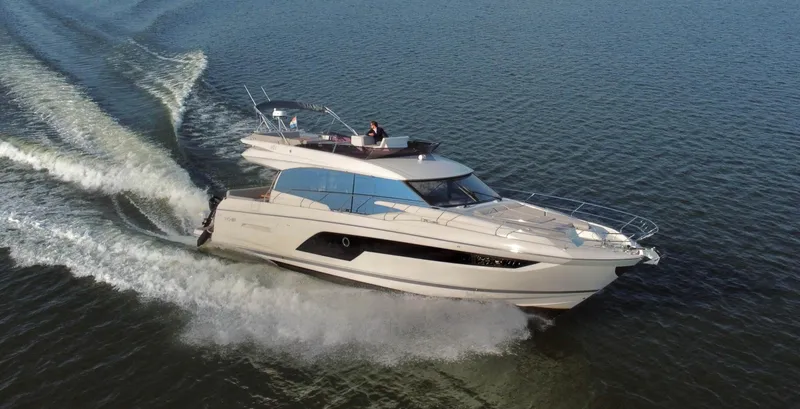  Yacht Photos Pics Luxurious 2019 Prestige 590 yacht cruising on open water, showcasing sleek design and performance.