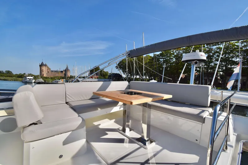  Yacht Photos Pics Luxurious 2019 Prestige 590 yacht with elegant seating and scenic waterfront view.