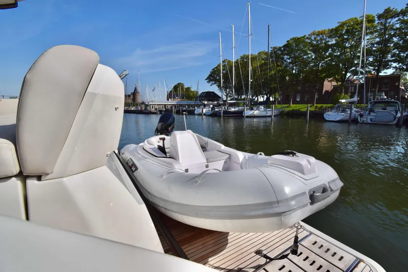  Yacht Photos Pics Luxury yacht Prestige 590 (2019) with tender boat docked in scenic marina.