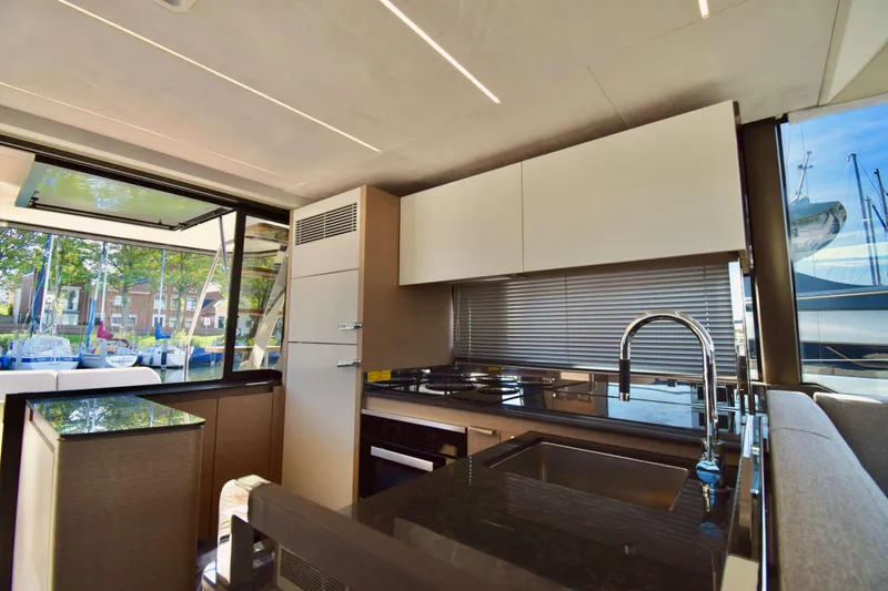  Yacht Photos Pics Luxurious kitchen interior of 2019 Prestige 590 yacht with modern design and sleek finishes.