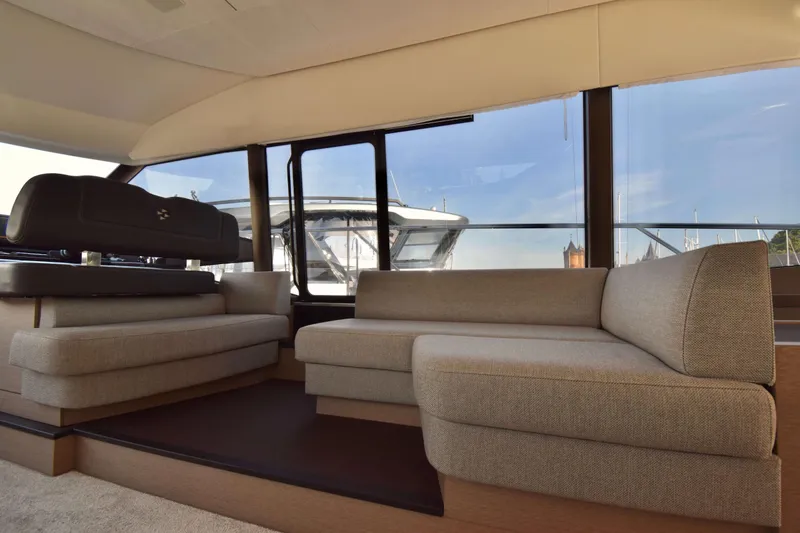  Yacht Photos Pics Luxurious interior of 2019 Prestige 590 yacht with modern seating and panoramic windows.