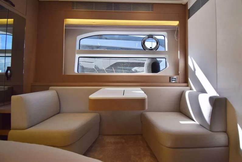  Yacht Photos Pics Luxurious interior of 2019 Prestige 590 yacht with elegant seating and large window.