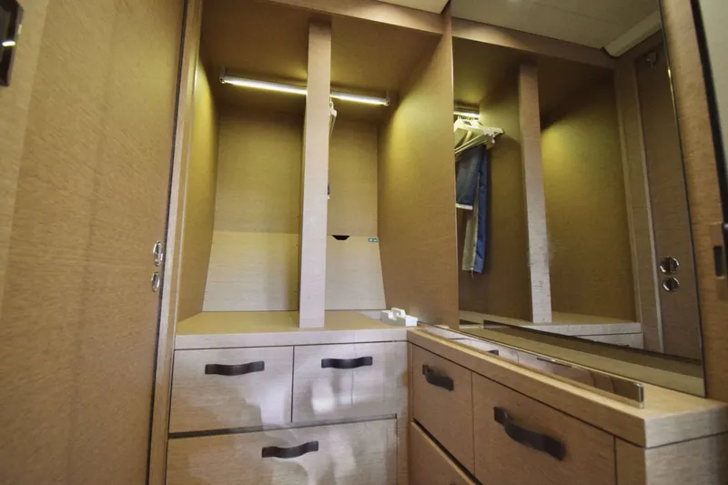  Yacht Photos Pics Luxurious wooden wardrobe interior on a 2019 Prestige 590 yacht, featuring ample storage and modern design.