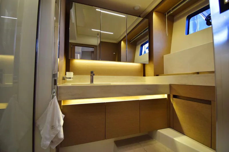  Yacht Photos Pics Luxurious bathroom interior of 2019 Prestige 590 yacht with modern fixtures and ambient lighting.