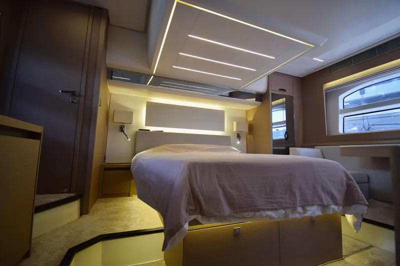  Yacht Photos Pics Luxurious interior of 2019 Prestige 590 yacht with modern bedroom design and ambient lighting.
