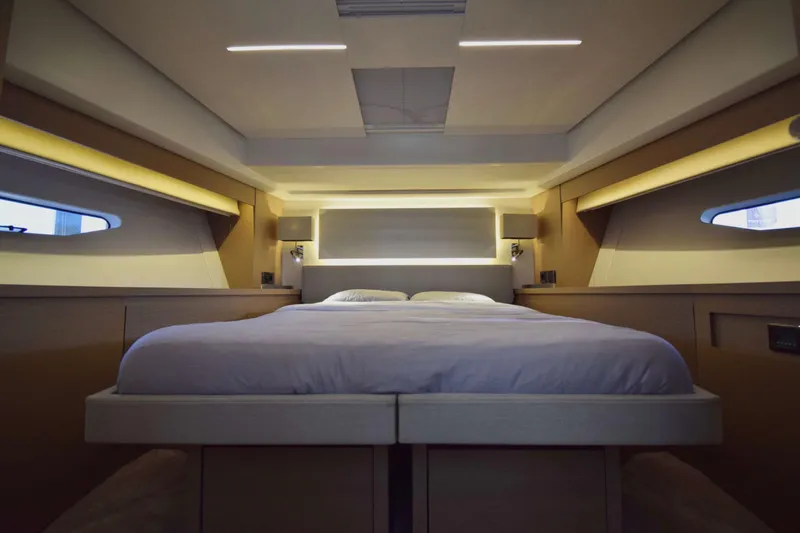  Yacht Photos Pics Luxurious bedroom interior of 2019 Prestige 590 yacht with modern lighting and sleek design.