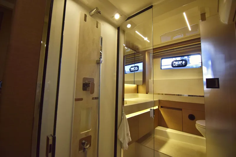  Yacht Photos Pics Luxurious bathroom interior of 2019 Prestige 590 yacht with modern fixtures and lighting.
