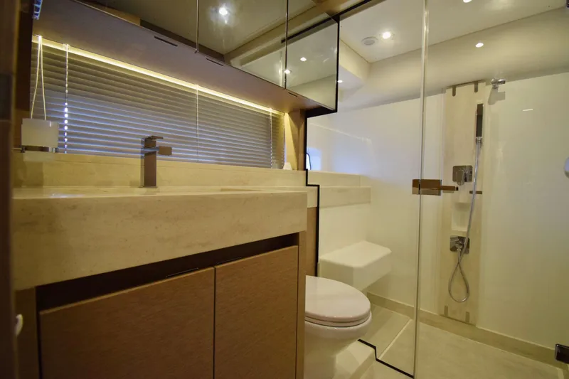  Yacht Photos Pics Luxurious bathroom in 2019 Prestige 590 yacht with modern fixtures and glass shower.