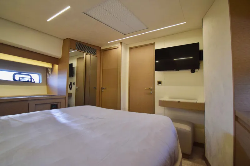  Yacht Photos Pics Luxurious interior of 2019 Prestige 590 yacht bedroom with modern decor and TV.