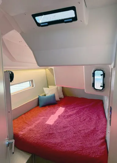  Yacht Photos Pics 2023 Beneteau Oceanis 40.1 cabin with red bedding and porthole windows.