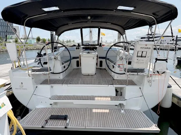  Yacht Photos Pics 2023 Beneteau Oceanis 40.1 yacht with dual steering wheels, docked at a marina.
