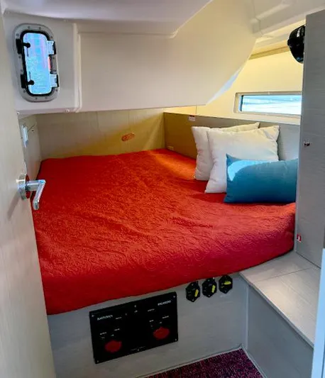  Yacht Photos Pics 2023 Beneteau Oceanis 40.1 cabin with red bedding and modern interior design.