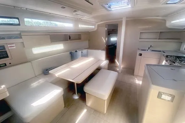  Yacht Photos Pics Interior of 2023 Beneteau Oceanis 40.1 yacht, featuring modern dining and kitchen area.