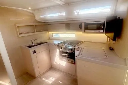  Yacht Photos Pics 2023 Beneteau Oceanis 40.1 yacht kitchen with modern appliances and sleek design.