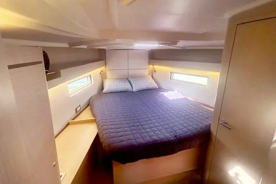  Yacht Photos Pics 2023 Beneteau Oceanis 40.1 yacht cabin with cozy bed and modern design.