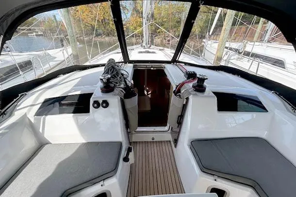  Yacht Photos Pics 2023 Beneteau Oceanis 40.1 yacht cockpit with seating and winches, docked in a marina.