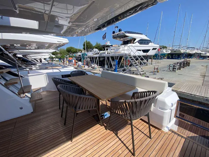 Lf Yacht Photos Pics Outdoor dining area on 2023 Ferretti Yachts 720, featuring elegant seating and wooden deck.