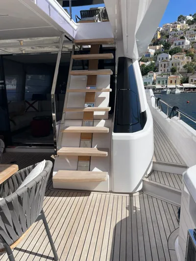Lf Yacht Photos Pics 2023 Ferretti Yachts 720 deck with stairs, overlooking coastal scenery.