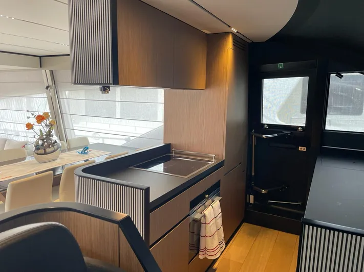 Lf Yacht Photos Pics Luxurious interior of 2023 Ferretti Yachts 720, featuring modern kitchen and dining area.