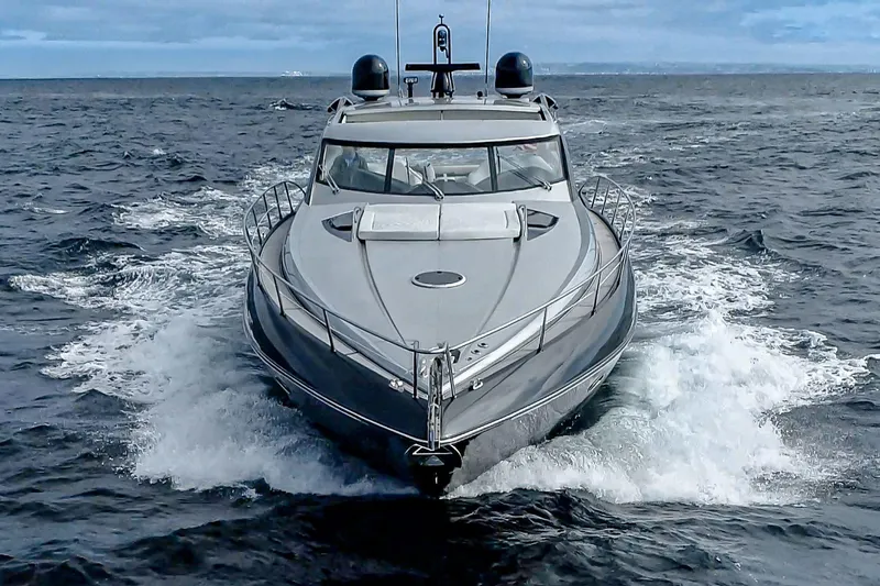  Yacht Photos Pics 2005 Sunseeker Predator 68 yacht cruising on open sea, front view.