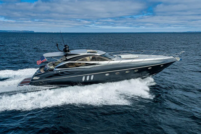  Yacht Photos Pics 2005 Sunseeker Predator 68 yacht cruising on open water under a cloudy sky.