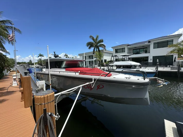  Yacht Photos Pics 2021 Axopar 37 XC Cross Cabin Brabus docked by waterfront homes.