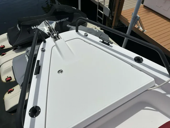 Yacht Photos Pics 2021 Axopar 37 XC Cross Cabin Brabus boat deck with railing and docked jet skis.