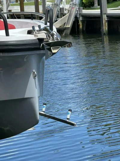  Yacht Photos Pics Axopar 37 XC Cross Cabin Brabus 2021 docked, showing hull and water reflection.