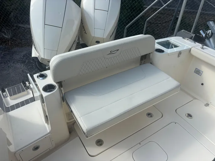  Yacht Photos Pics 2025 Scout 277 LXF boat seating area with dual engines and cup holders.