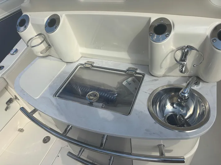  Yacht Photos Pics 2025 Scout 277 LXF boat interior with sink and storage compartments.
