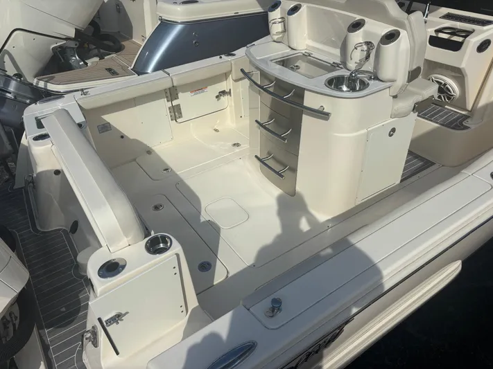  Yacht Photos Pics 2025 Scout 277 LXF boat interior with seating and storage compartments.