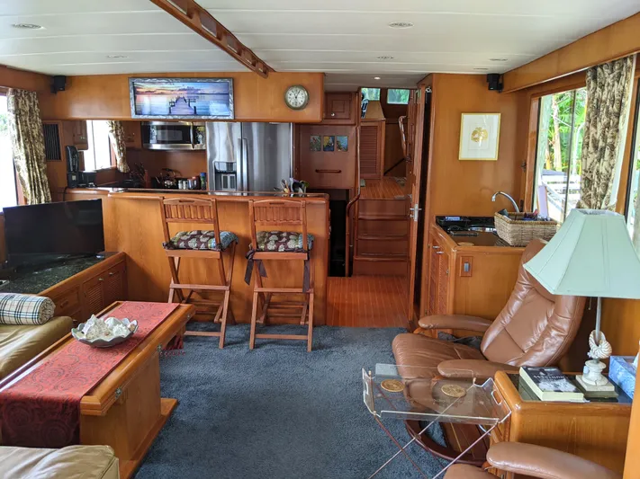 Pura Vida III Yacht Photos Pics 1999 Grand Alaskan Pilothouse yacht interior with modern kitchen and cozy living area.