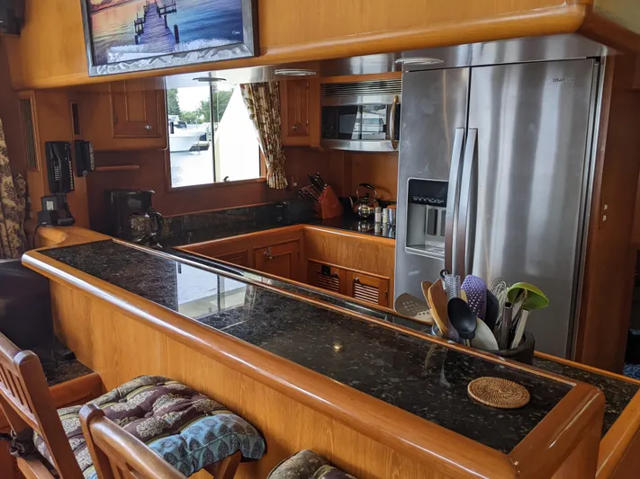 Pura Vida III Yacht Photos Pics 1999 Grand Alaskan Pilothouse kitchen with granite countertops and stainless steel appliances.