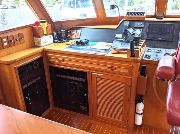 Pura Vida III Yacht Photos Pics 1999 Grand Alaskan Pilothouse interior with navigation equipment and wooden cabinetry.