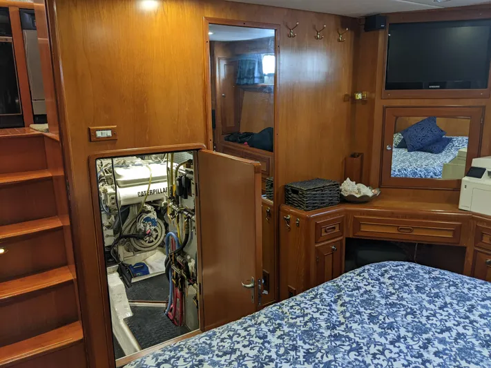Pura Vida III Yacht Photos Pics 1999 Grand Alaskan Pilothouse interior with wooden cabinetry, bed, and engine room access.