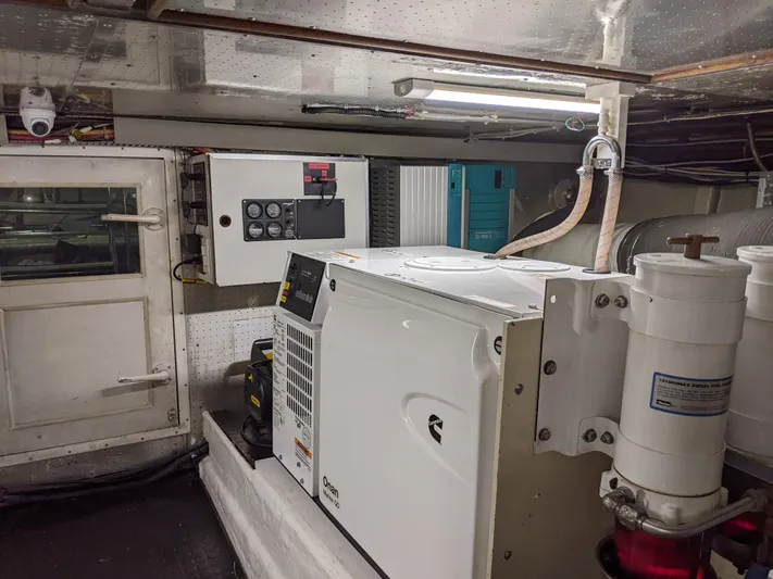 Pura Vida III Yacht Photos Pics Engine room of a 1999 Grand Alaskan Pilothouse yacht with generator and control panel.