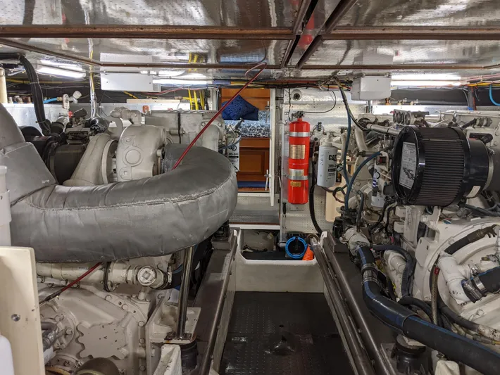 Pura Vida III Yacht Photos Pics Engine room of a 1999 Grand Alaskan Pilothouse yacht, showcasing machinery and equipment.