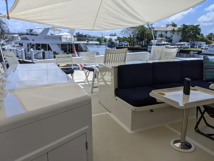 Pura Vida III Yacht Photos Pics 1999 Grand Alaskan Pilothouse yacht deck with seating area and marina view.