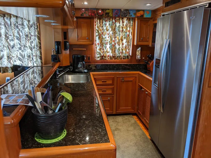 Pura Vida III Yacht Photos Pics 1999 Grand Alaskan Pilothouse kitchen with stainless steel appliances and granite countertops.