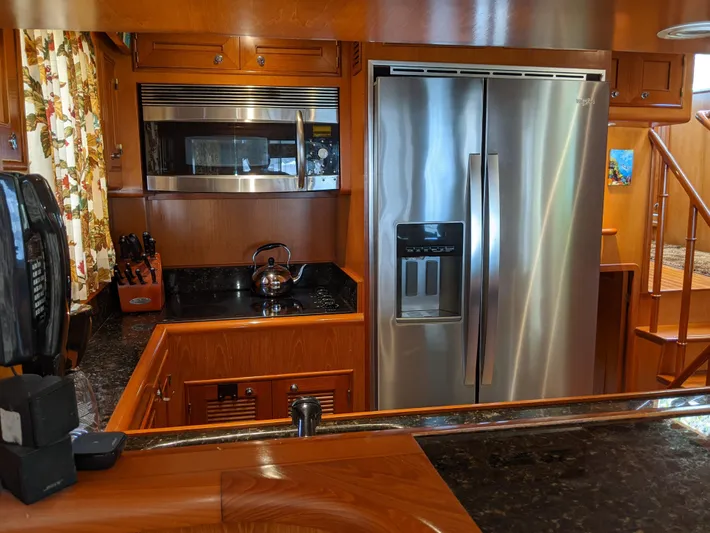 Pura Vida III Yacht Photos Pics Modern kitchen in a 1999 Grand Alaskan Pilothouse yacht with stainless steel appliances.