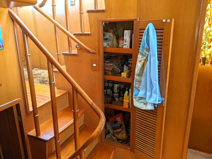 Pura Vida III Yacht Photos Pics Wooden staircase and pantry in a 1999 Grand Alaskan Pilothouse yacht.